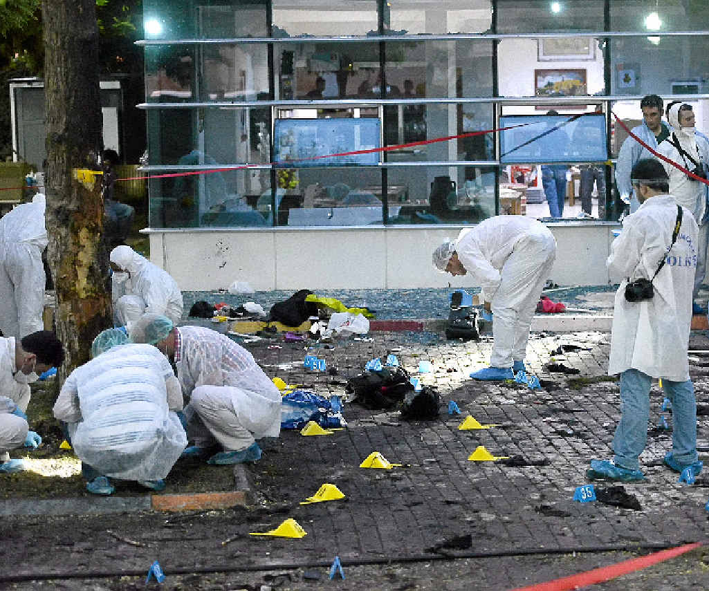 GRIM TASK: Turkish forensic police get down to business at the scene of the explosion in Suruc. GRIM TASK: Turkish forensic police get down to business at the scene of the explosion in Suruc.