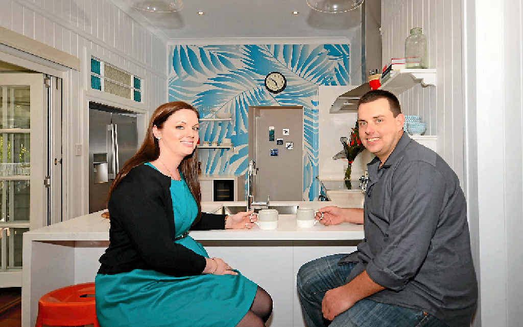 SMILES ALL ROUND: South Australian couple Jessica Yates and Jarrod Bennett sit in the kitchen of their new home in Toogoom. SMILES ALL ROUND: South Australian couple Jessica Yates and Jarrod Bennett sit in the kitchen of their new home in Toogoom.