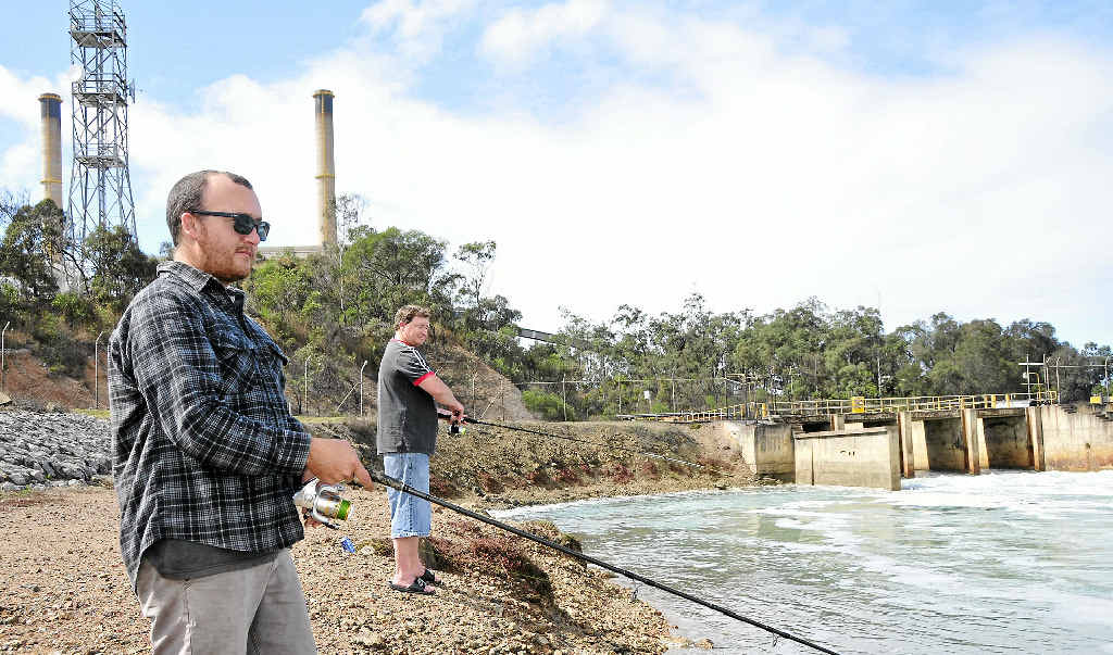Jay Absalom fishing for barra at the hot water outlet in Gladstone with his mate Travis Williams, after they knocked off work at 6am. Jay Absalom fishing for barra at the hot water outlet in Gladstone with his mate Travis Williams, after they knocked off work at 6am.