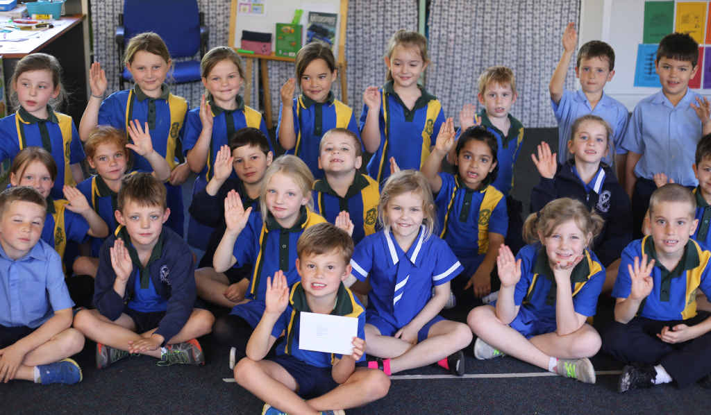 THE ROYALS: Class 1J were happy to give us a royal wave. INSETS: The gifts in the package for the kids. THE ROYALS: Class 1J were happy to give us a royal wave. INSETS: The gifts in the package for the kids.