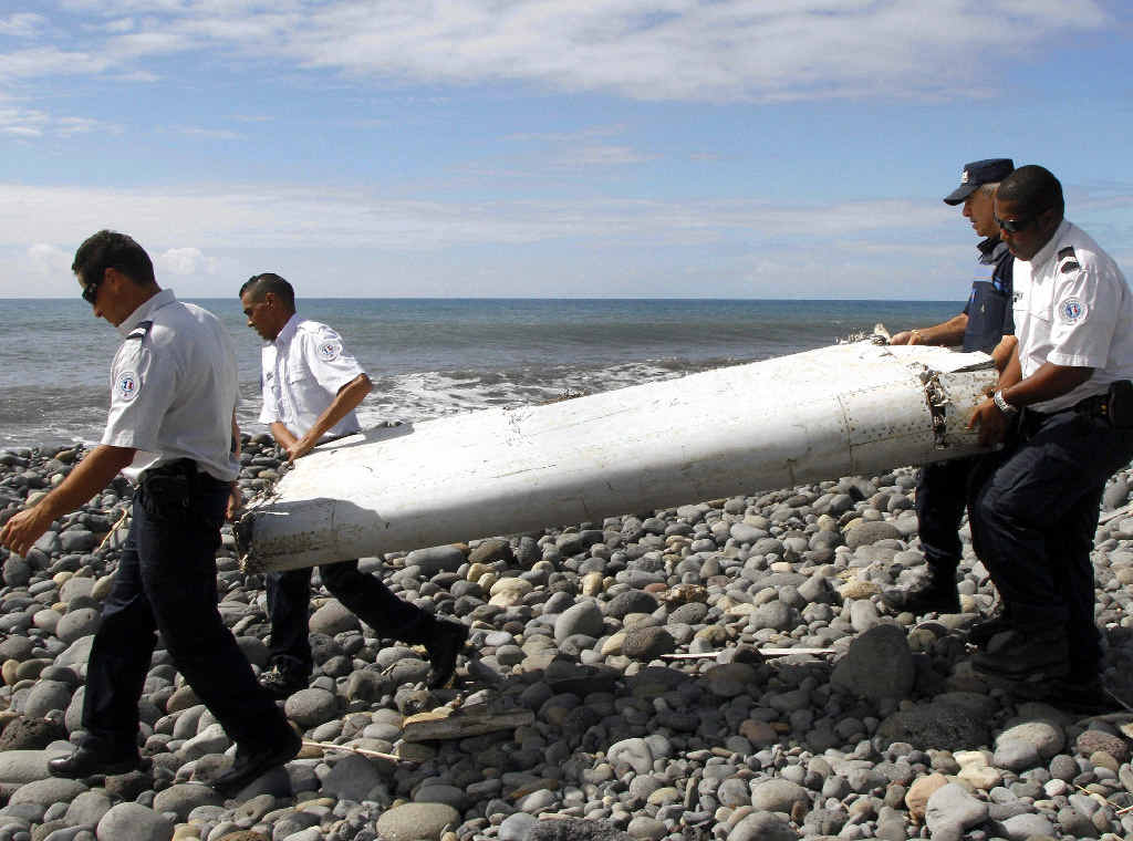 NEW HOPE: Officers carrying pieces of debris from an unidentified aircraft apparently washed ashore in Saint-Andre de la Reunion, eastern La Reunion island, France, late last week. A Malaysian government team has been dispatched to Reunion in the Indian Ocean, where newly found aircraft wreckage awakened speculation over flight MH370. NEW HOPE: Officers carrying pieces of debris from an unidentified aircraft apparently washed ashore in Saint-Andre de la Reunion, eastern La Reunion island, France, late last week. A Malaysian government team has been dispatched to Reunion in the Indian Ocean, where newly found aircraft wreckage awakened speculation over flight MH370.