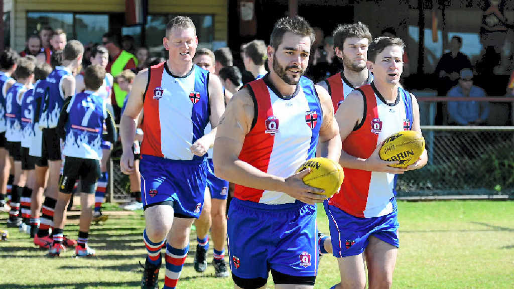 PROUD HERITAGE: Daniel Clacy leads out the South Burnett Saints out in old Bulldog jerseys to play the Chinchilla Suns. Ty Snow takes a handy mark for the Saints.Daniel Rogers takes a shot at goal. PROUD HERITAGE: Daniel Clacy leads out the South Burnett Saints out in old Bulldog jerseys to play the Chinchilla Suns. Ty Snow takes a handy mark for the Saints.Daniel Rogers takes a shot at goal.
