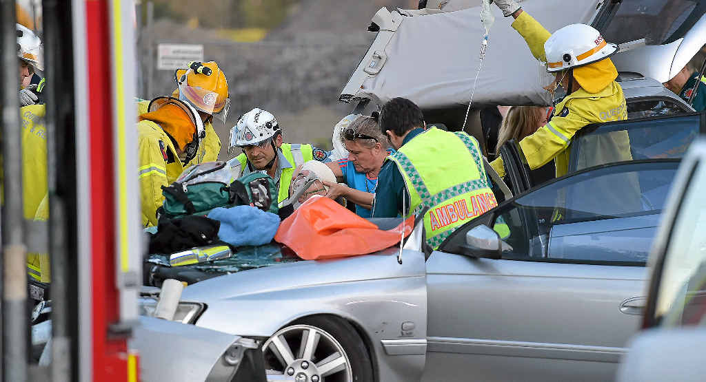 TRAPPED: Emergency services personnel work to free a man from a crash at Marcoola yesterday. TRAPPED: Emergency services personnel work to free a man from a crash at Marcoola yesterday.