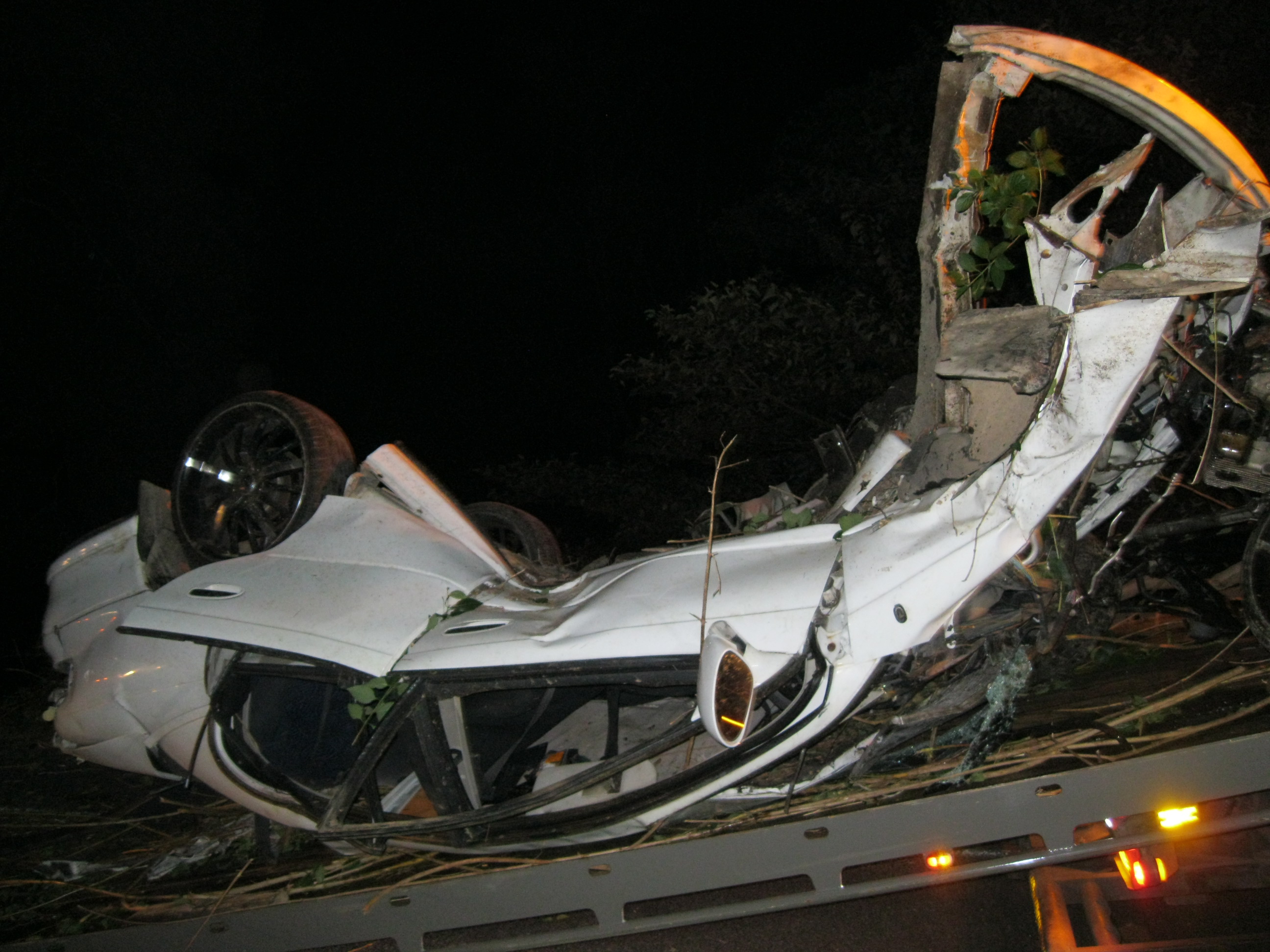 The wreck of a car that hit a tree after leaving the road at Cooroy. Somehow the three people inside survived. The wreck of a car that hit a tree after leaving the road at Cooroy. Somehow the three people inside survived.