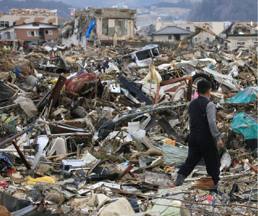 HORROR SCENE: A man walks through debris in tsunami-devastated city of Rikuzentakata in northern Japan in 2011. HORROR SCENE: A man walks through debris in tsunami-devastated city of Rikuzentakata in northern Japan in 2011.