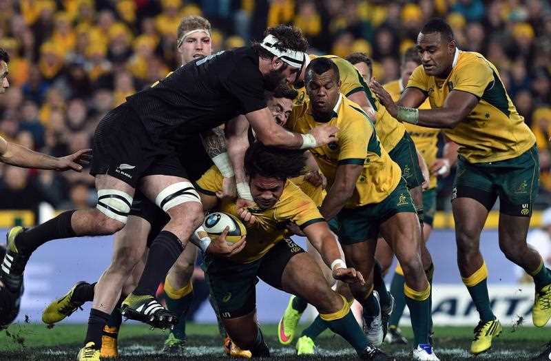 New Zealand All Blacks Samuel Whitelock (L) tackles Australia's Tatafu Polota-Nau (C) during the Bledisloe Cup Test match as part of the Rugby Championship in Sydney on August 8, 2015. New Zealand All Blacks Samuel Whitelock (L) tackles Australia's Tatafu Polota-Nau (C) during the Bledisloe Cup Test match as part of the Rugby Championship in Sydney on August 8, 2015.