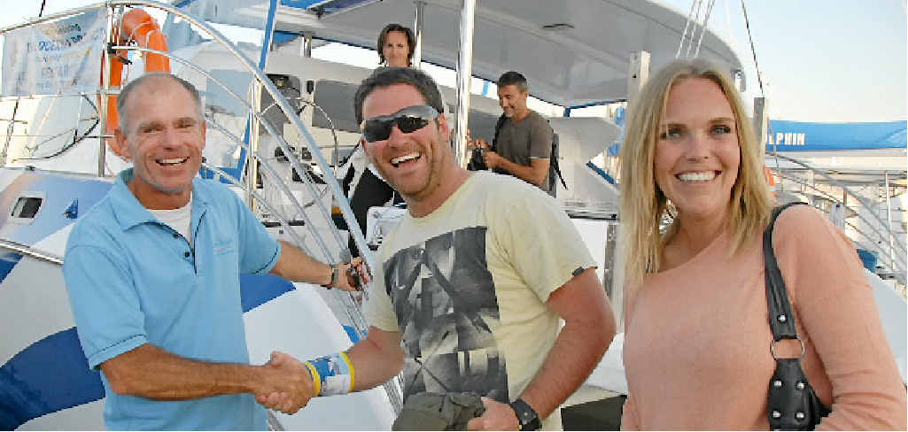 REPRISED DATE: Blue Dolphin owner Peter Lynch greets the couple. RIGHT: Tim and Janette Irwin greet a humpback whale frolicking close to the Blue Dolphin. REPRISED DATE: Blue Dolphin owner Peter Lynch greets the couple. RIGHT: Tim and Janette Irwin greet a humpback whale frolicking close to the Blue Dolphin.