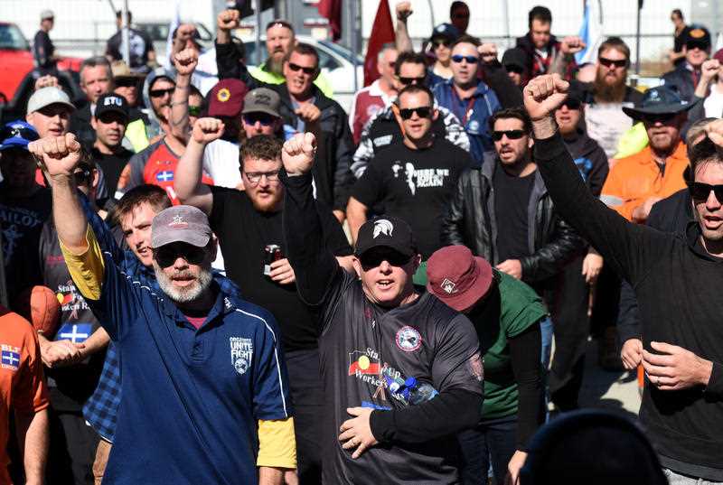 Trade union members chant as they block the entry road to Berth 11 at the Port of Brisbane, Monday, Aug. 10, 2015. Protesters have gathered at the port of Brisbane and in Sydney, furious with Hutchison Ports for sacking 97 staff across the two cities late last Thursday night via text and email, citing substantial financial losses. Trade union members chant as they block the entry road to Berth 11 at the Port of Brisbane, Monday, Aug. 10, 2015. Protesters have gathered at the port of Brisbane and in Sydney, furious with Hutchison Ports for sacking 97 staff across the two cities late last Thursday night via text and email, citing substantial financial losses.