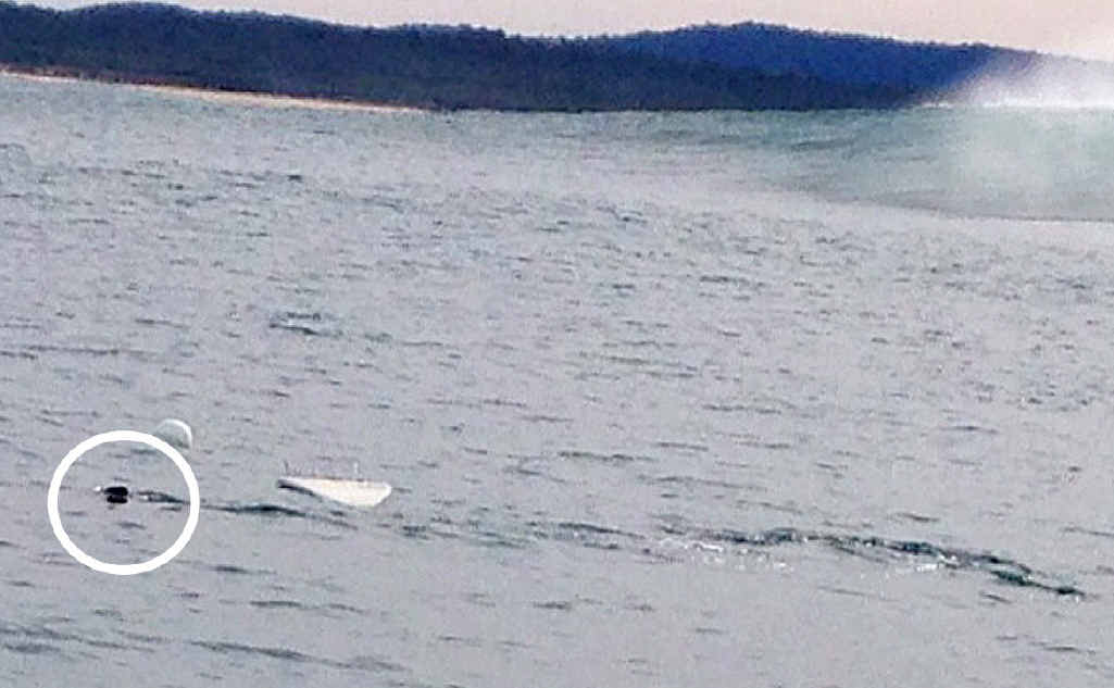 CLOSE ENCOUNTER: This photo shows the tip of the shark’s fin after it circled the anchored board at a big wave spot south of Evans Head. The white water to the right is where it surfaced. BELOW: A photo taken of Mick McGillivray surfing a left-hand barrel on the same day at the same spot shortly before the encounter with the suspected three-metre great white. CLOSE ENCOUNTER: This photo shows the tip of the shark’s fin after it circled the anchored board at a big wave spot south of Evans Head. The white water to the right is where it surfaced. BELOW: A photo taken of Mick McGillivray surfing a left-hand barrel on the same day at the same spot shortly before the encounter with the suspected three-metre great white.