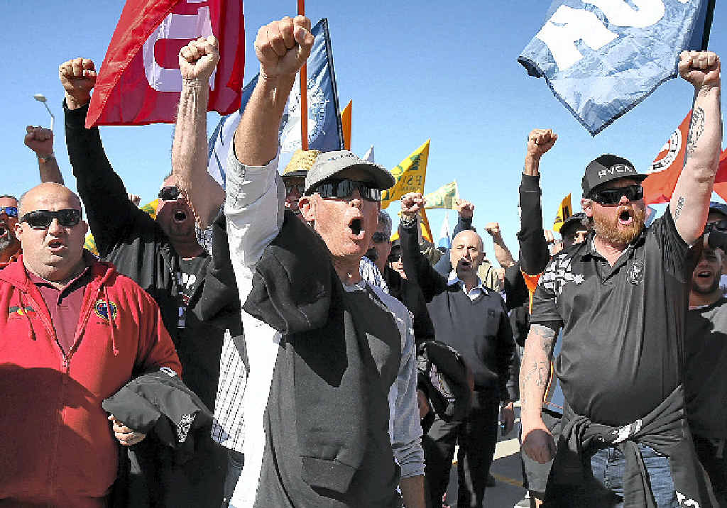 ROUND ONE: Union members cheer as Hutchison Ports employees return to work in Sydney yesterday after several days of industrial action. ROUND ONE: Union members cheer as Hutchison Ports employees return to work in Sydney yesterday after several days of industrial action.