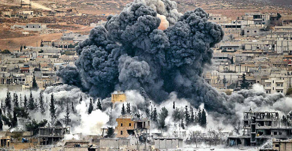 AIR STRIKE: Smoke rises from the Syrian city of Kobani. AIR STRIKE: Smoke rises from the Syrian city of Kobani.