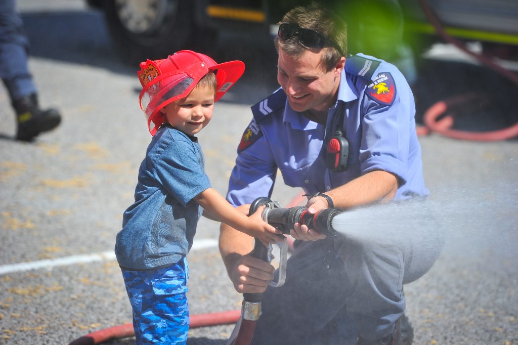 Hugo Butler, 3, has a go at using the water hose. Hugo Butler, 3, has a go at using the water hose.