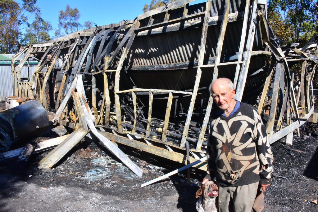 Roy Morrison and his dog Whitey with what is left of their home. Roy Morrison and his dog Whitey with what is left of their home.