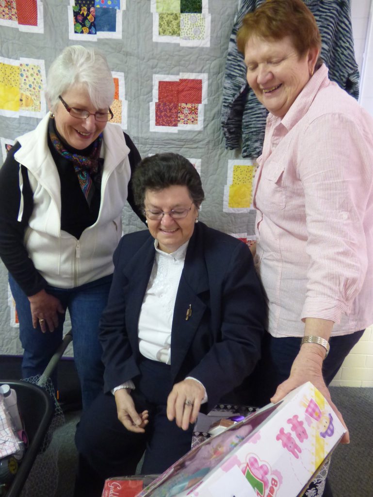 Patricia Stevens, Chris Green and Jan Barrett admire the generous donations made to their best-ever multi-draw raffle in aid of Parkinson's sufferers. 