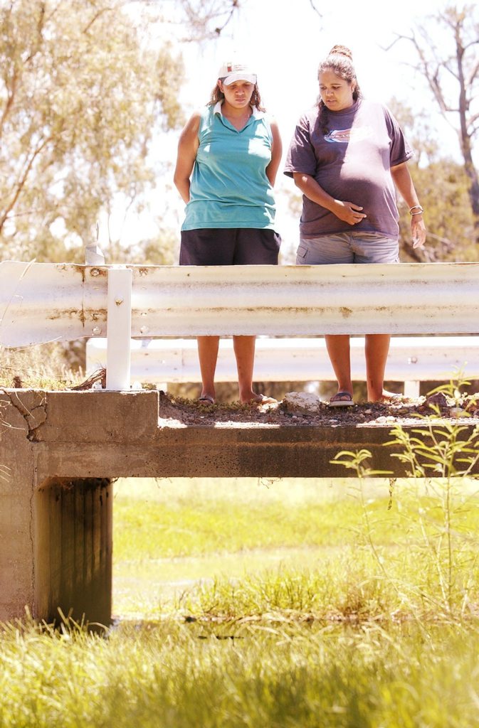 Daughters Daylene and Hannah Barlow stand over the culvert where their mother's body was found. Daughters Daylene and Hannah Barlow stand over the culvert where their mother's body was found.