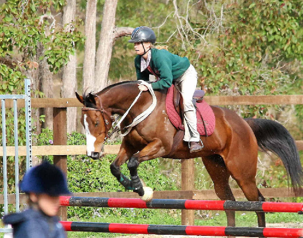 Erin Newman clears a jump in the showjumping. Erin Newman clears a jump in the showjumping.