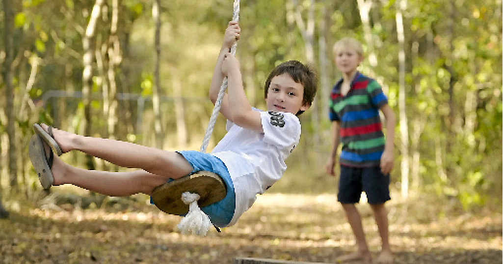COUNTRY SOUNDS: Thomas Beard, 7, and Brayden Smith, 9, enjoy the big swing and children (right) from the Matsikire and Kahondo familles enjoy the bushland setting. COUNTRY SOUNDS: Thomas Beard, 7, and Brayden Smith, 9, enjoy the big swing and children (right) from the Matsikire and Kahondo familles enjoy the bushland setting.