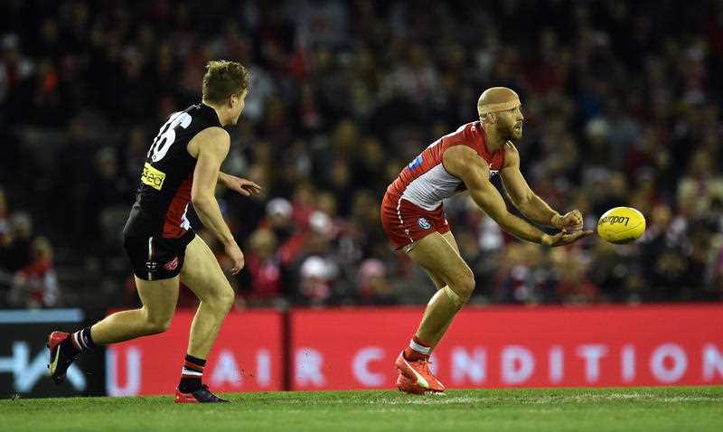 Sydney Swans player Jarrad McVeigh (right) handballs as St Kilda Saints player Jack Newnes chases in round 22 of the AFL at Etihad Stadium in Melbourne, Sunday, Aug 29, 2015. Sydney Swans player Jarrad McVeigh (right) handballs as St Kilda Saints player Jack Newnes chases in round 22 of the AFL at Etihad Stadium in Melbourne, Sunday, Aug 29, 2015.