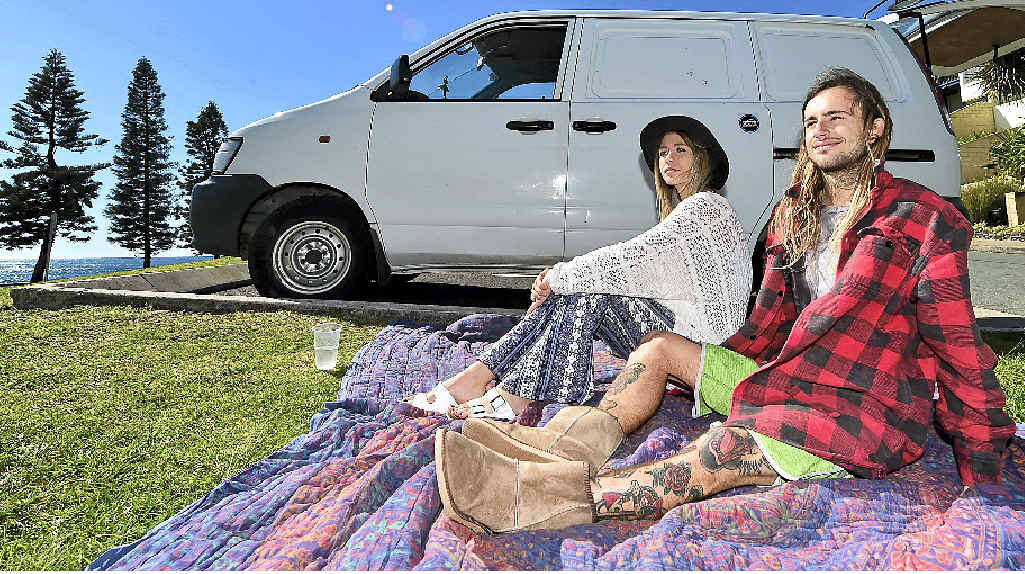 ROBBERY SCENE: Jy-Leigh Wilson and Toby Vergens relax near a Moffat Beach car park yesterday where they witnessed a police search on Monday night. ROBBERY SCENE: Jy-Leigh Wilson and Toby Vergens relax near a Moffat Beach car park yesterday where they witnessed a police search on Monday night.