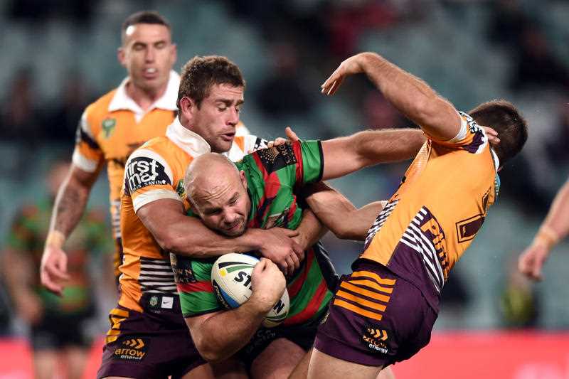 Glenn Stewart (centre) of the Rabbitohs is tackled by Ben Hunt (right) and Andrew McCullough of the Broncos during the round 25 NRL match between the South Sydney Rabbitohs and the Brisbane Broncos at Allianz Stadium in Sydney on Thursday, Aug. 27, 2015. Glenn Stewart (centre) of the Rabbitohs is tackled by Ben Hunt (right) and Andrew McCullough of the Broncos during the round 25 NRL match between the South Sydney Rabbitohs and the Brisbane Broncos at Allianz Stadium in Sydney on Thursday, Aug. 27, 2015.