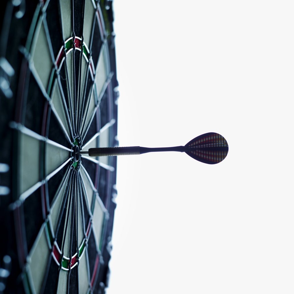 Close-up of dartboard with dart on the bulls eye