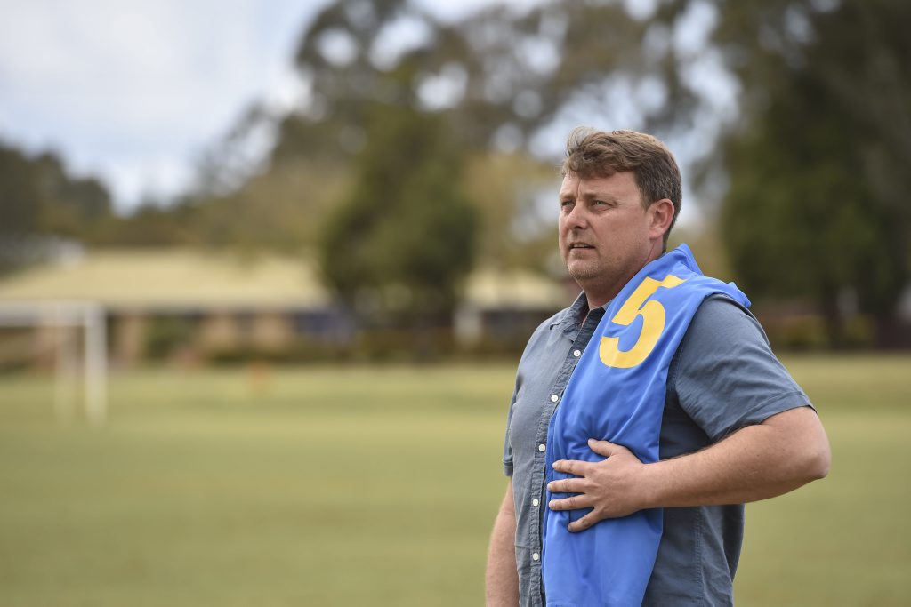 Dan Percy with his son's football jersey. Dan Percy with his son's football jersey.