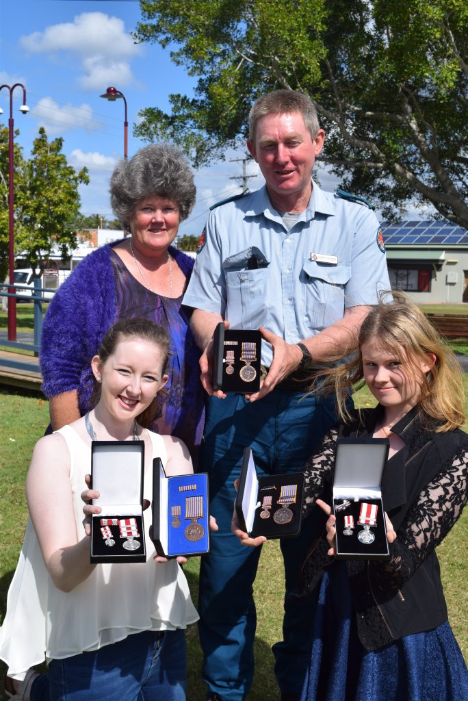 EFFORT AWARDED: Critical care paramedic Darrell Searle helps has help holding his stash of awards with wife Myra and daughters (L-R) Tegan and Jocelyn. EFFORT AWARDED: Critical care paramedic Darrell Searle helps has help holding his stash of awards with wife Myra and daughters (L-R) Tegan and Jocelyn.