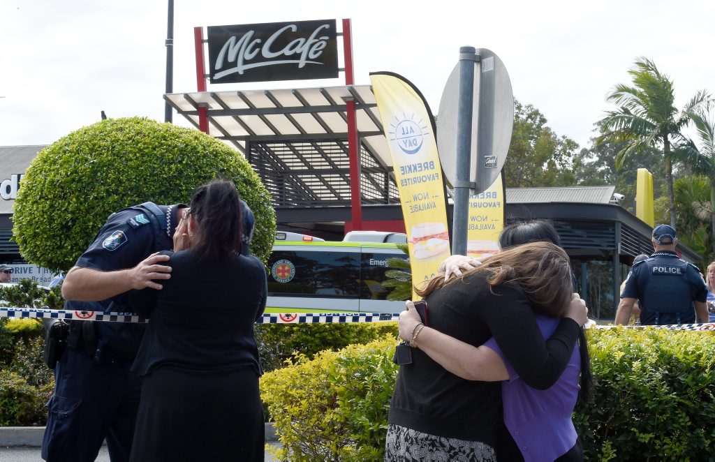 People react following a shooting at a McDonalds restaurant in Helensvale on the Gold Coast. People react following a shooting at a McDonalds restaurant in Helensvale on the Gold Coast.
