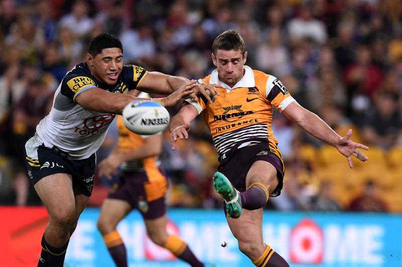 Andrew McCullough of the Brisbane Broncos (right) kicks past Jason Taumalolo of the North Queensland Cowboys during their Qualifying Final game at Suncorp Stadium in Brisbane, Saturday, Sept. 12, 2015. Andrew McCullough of the Brisbane Broncos (right) kicks past Jason Taumalolo of the North Queensland Cowboys during their Qualifying Final game at Suncorp Stadium in Brisbane, Saturday, Sept. 12, 2015.