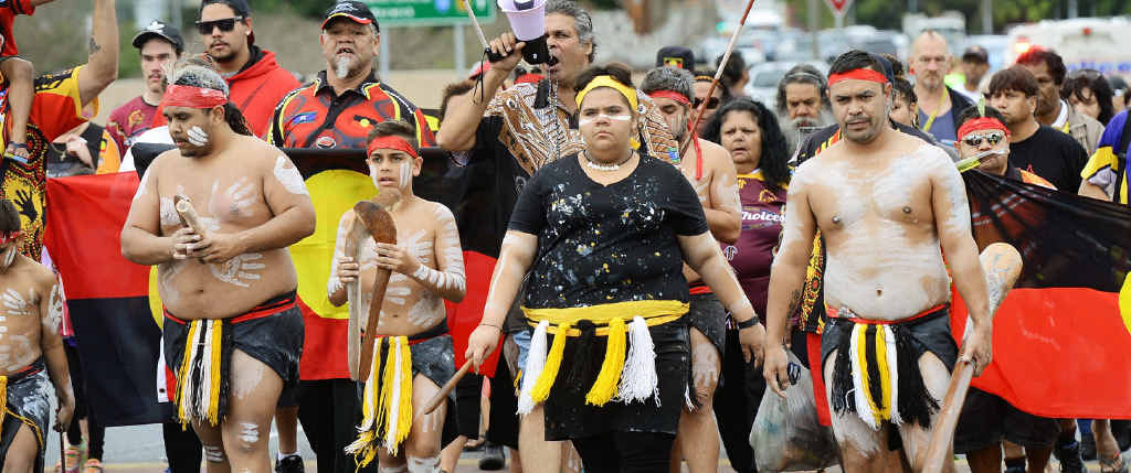 ON A MISSION: Indigenous protesters walk through the Ipswich CBD to voice concerns over the development.