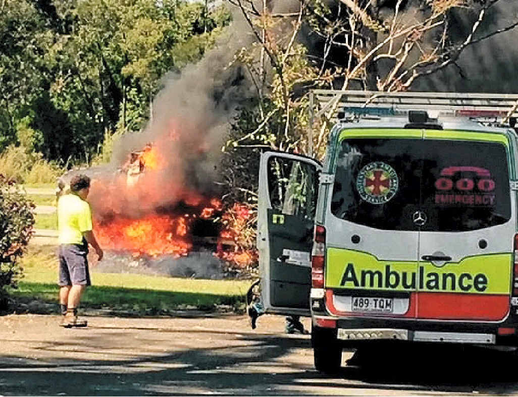 IN AWE: Passers-by watch the fire take hold. IN AWE: Passers-by watch the fire take hold.