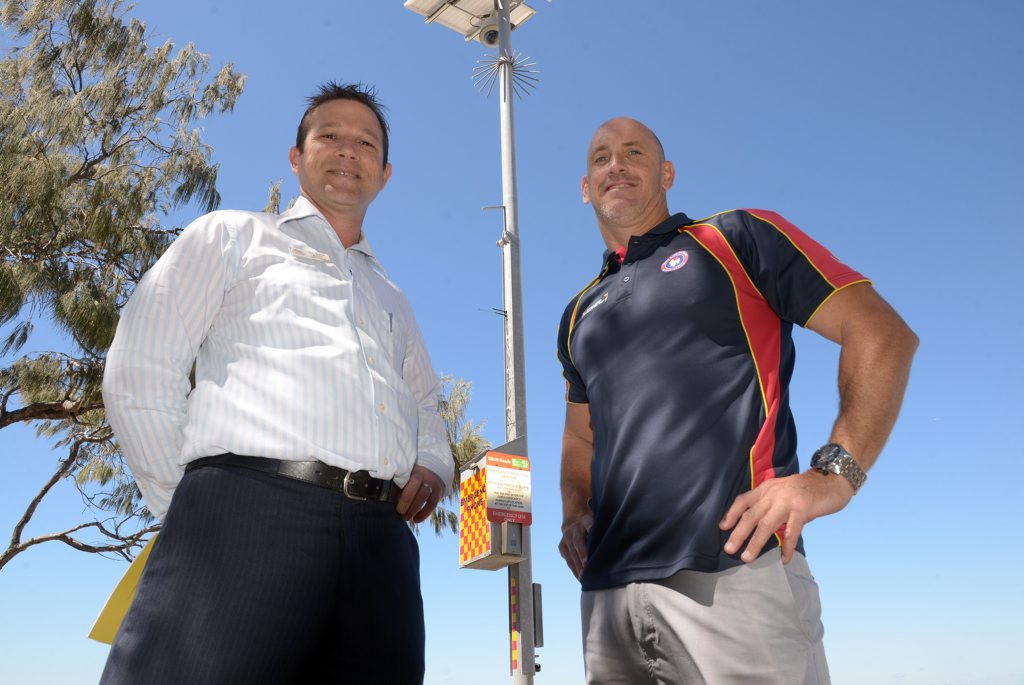 NEW SAFETY FEATURES: Hundreds of volunteer surf lifesavers will return to the beach this Saturday when Surf Life Saving Queensland (SLSQ) kicks off its 2015/16 volunteer patrol season. Bundaberg deputy mayor David Batt and SLSQ Wide Bay regional manager Craig Holden are proud to announce that Elliott Heads beach has a new emergency phone and video camera. Photo: Max Fleet / NewsMail NEW SAFETY FEATURES: Hundreds of volunteer surf lifesavers will return to the beach this Saturday when Surf Life Saving Queensland (SLSQ) kicks off its 2015/16 volunteer patrol season. Bundaberg deputy mayor David Batt and SLSQ Wide Bay regional manager Craig Holden are proud to announce that Elliott Heads beach has a new emergency phone and video camera. Photo: Max Fleet / NewsMail