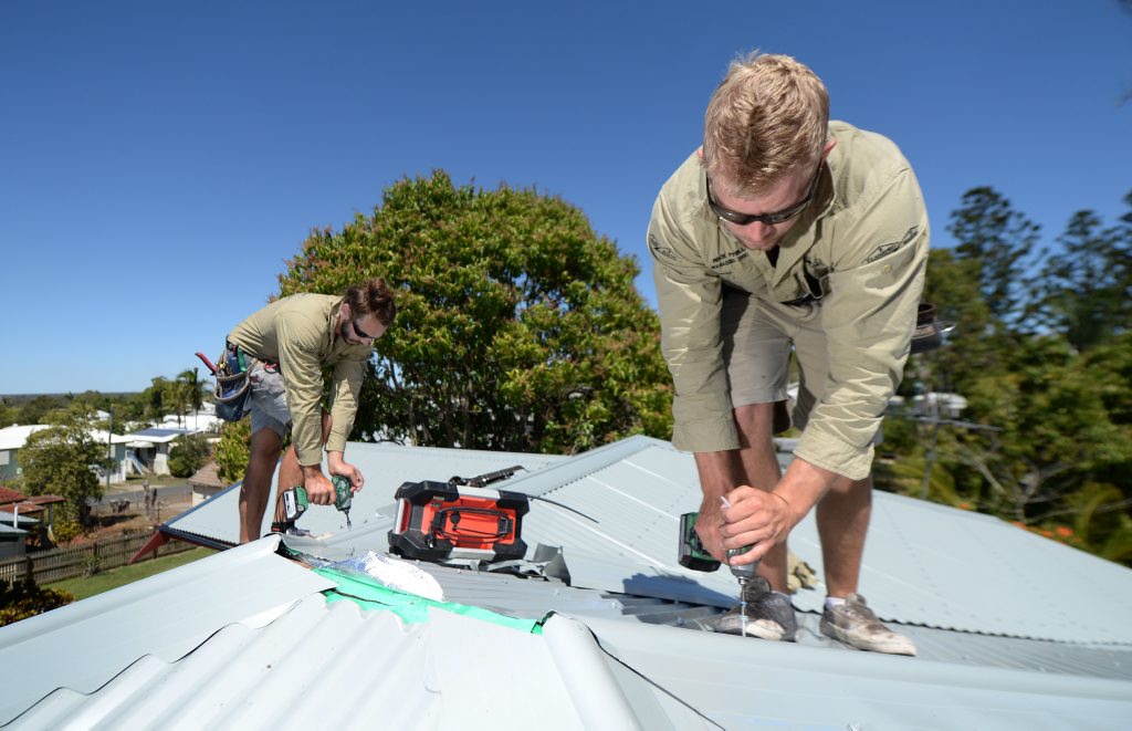 Nick Phillips owner/manager of Flashpro Roofing (right) with Sam Smith putting the finishing touches on a new roof after the old asbestos one was replaced Nick Phillips owner/manager of Flashpro Roofing (right) with Sam Smith putting the finishing touches on a new roof after the old asbestos one was replaced