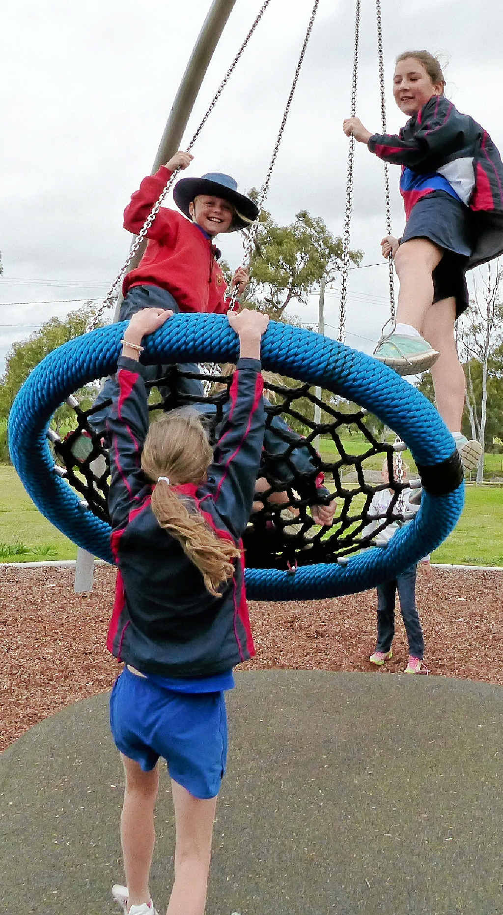 Maddie Kane gives Lilly Oloman (left) and Joy DeCourcy a push to get Rewards Day started.
