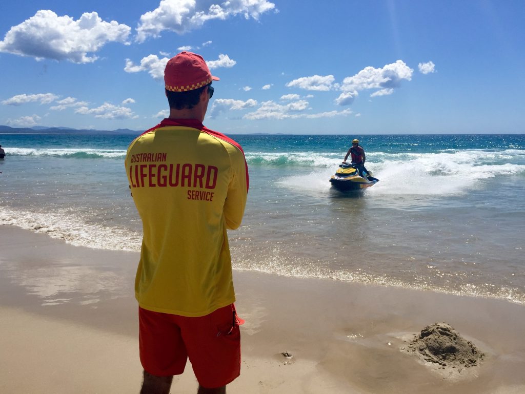 PATROL: Byron based lifesaver Lorne Greenlaw returns from patrolling off Main Beach Byron Bay watched by Jai Sheridan 