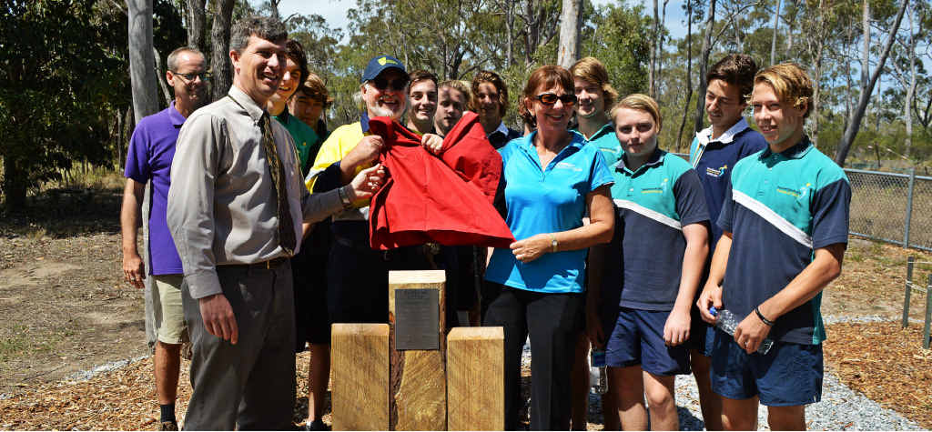 PROUD MOMENT: Tannum Sands State High School students celebrate their work with CQUniversity Construction teacher Ric Lane (hi-vis shirt), Todd Comrie (purple) and Owen Nevin (grey). PROUD MOMENT: Tannum Sands State High School students celebrate their work with CQUniversity Construction teacher Ric Lane (hi-vis shirt), Todd Comrie (purple) and Owen Nevin (grey).