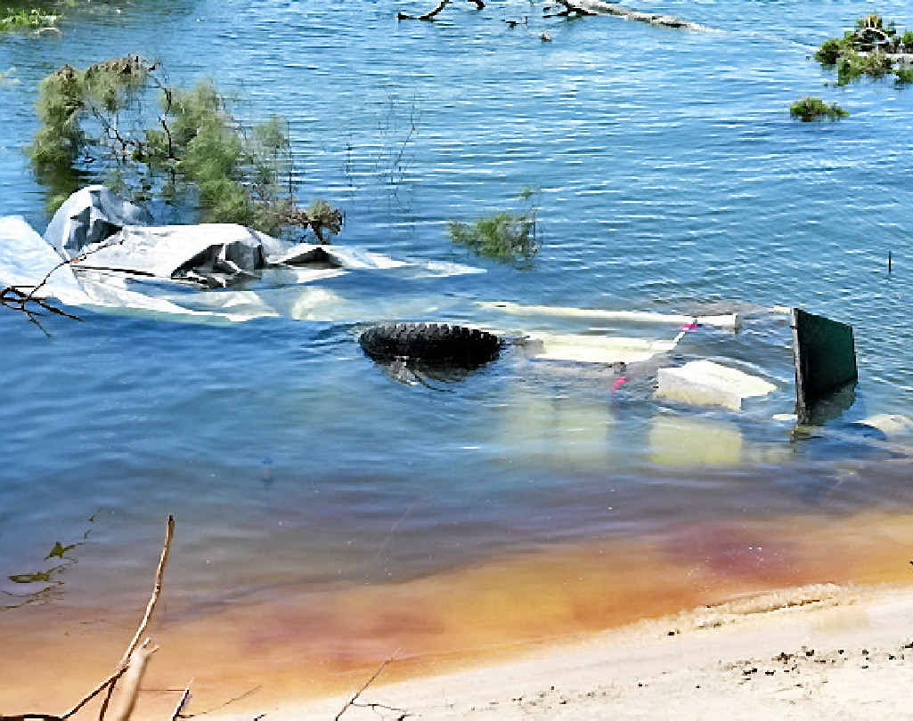 A vehicle swallowed by the sinkhole. A vehicle swallowed by the sinkhole.