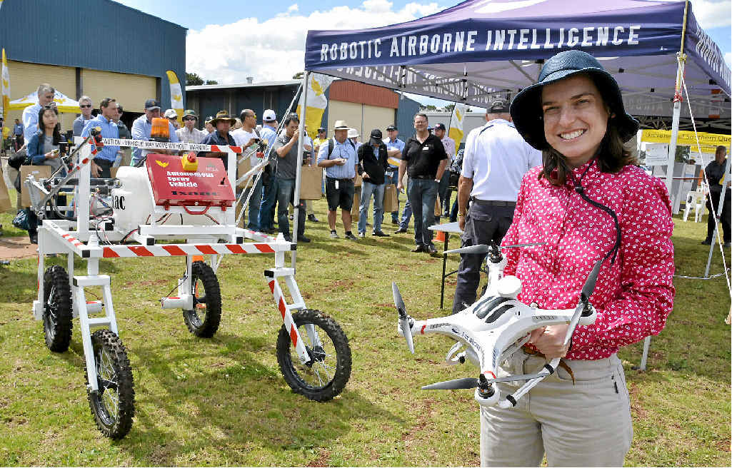 FUTURE OF FARMING: Mechatronic engineering research fellow Dr Cheryl McCarthy with a drone and a ground-based robot. FUTURE OF FARMING: Mechatronic engineering research fellow Dr Cheryl McCarthy with a drone and a ground-based robot.