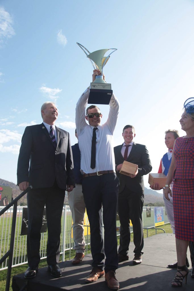 Honey Toast trainer Ben Currie holds up the Townsville Cup after jockey Paul Hammersly won the $60,000 race yesterday. Honey Toast trainer Ben Currie holds up the Townsville Cup after jockey Paul Hammersly won the $60,000 race yesterday.