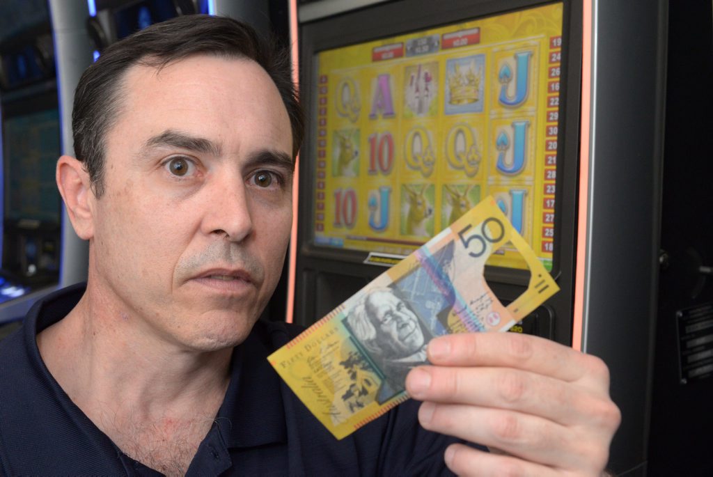 TAKE NOTE: Railway Hotel owner Steve Hooper is finding $50 notes with the holographic windows cut out in pokie machines. Photo: Max Fleet / NewsMail TAKE NOTE: Railway Hotel owner Steve Hooper is finding $50 notes with the holographic windows cut out in pokie machines. Photo: Max Fleet / NewsMail