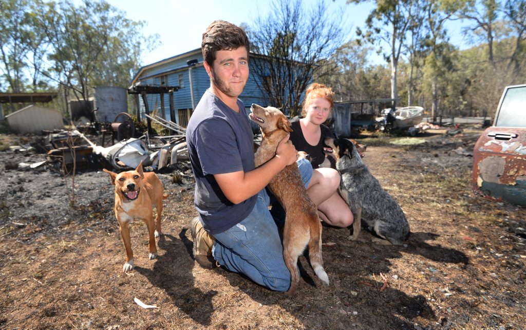 Ule Lopez and Brooke Moyle are just grateful that thier pet dogs are ok after a grassfire possibly lit by a man evading police burned right to the back steps of the house at the corner of the Burnett Highway and Leydens Hill Road, Struck Oil. Photo: Chris Ison / The Morning Bulletin Ule Lopez and Brooke Moyle are just grateful that thier pet dogs are ok after a grassfire possibly lit by a man evading police burned right to the back steps of the house at the corner of the Burnett Highway and Leydens Hill Road, Struck Oil. Photo: Chris Ison / The Morning Bulletin
