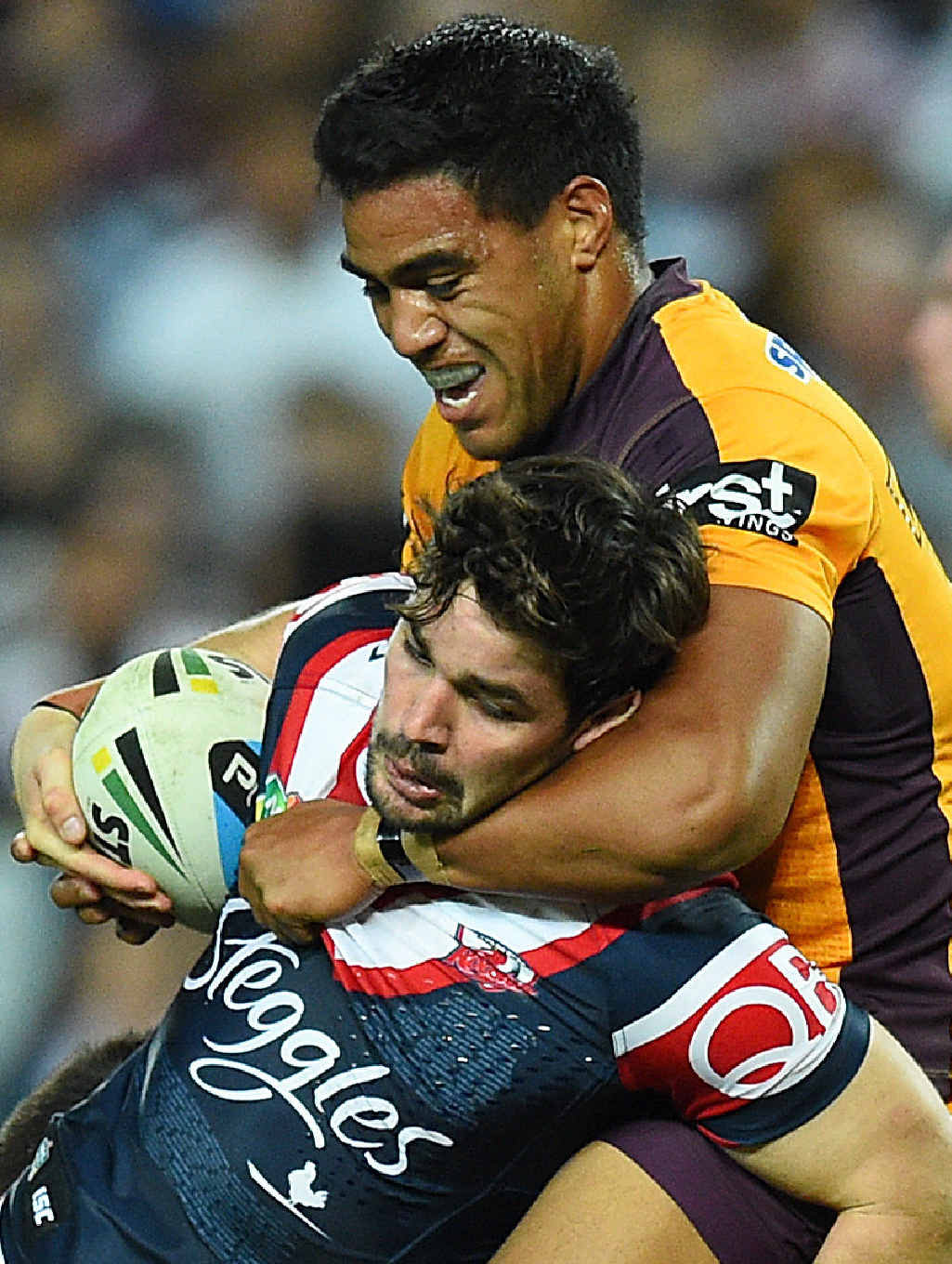 COP THAT: Aidan Guerra of the Roosters is hammered by Broncos prop Joe Ofahengaue. Big Joe will come off the bench in tomorrow’s NRL grand final. COP THAT: Aidan Guerra of the Roosters is hammered by Broncos prop Joe Ofahengaue. Big Joe will come off the bench in tomorrow’s NRL grand final.