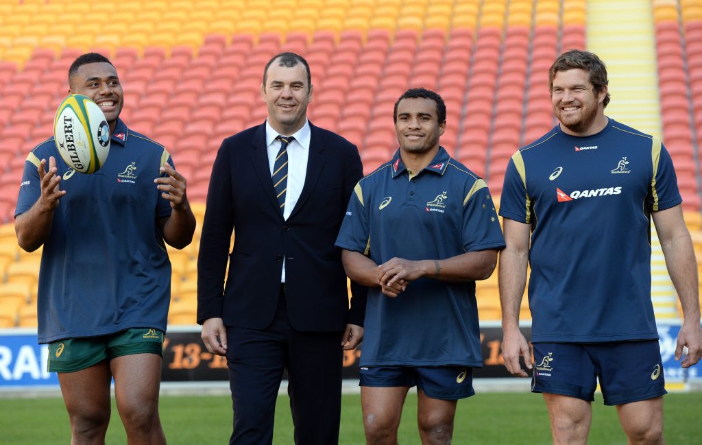 (L to R) Wallabies player Samu Kerevi, coach Michael Cheika and player Will Genia and Greg Holmes pose for a photo after naming the team for the upcoming Rugby Championship at Suncorp Stadium in Brisbane, Thursday, July 2, 2015. (AAP Image/Dan Peled) NO ARCHIVING (L to R) Wallabies player Samu Kerevi, coach Michael Cheika and player Will Genia and Greg Holmes pose for a photo after naming the team for the upcoming Rugby Championship at Suncorp Stadium in Brisbane, Thursday, July 2, 2015. (AAP Image/Dan Peled) NO ARCHIVING