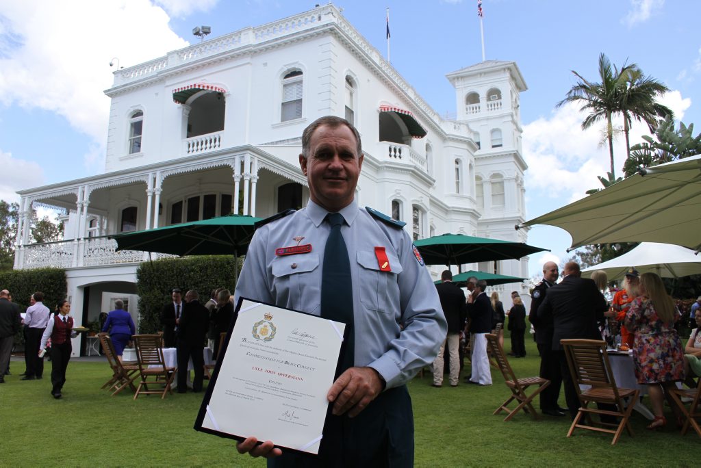 HONOURED: Maryborough paramedic Lyle Oppermann receives a bravery award at Government House for saving two children and their mother from a house fire. photo Contributed / Fraser Coast Chronicle HONOURED: Maryborough paramedic Lyle Oppermann receives a bravery award at Government House for saving two children and their mother from a house fire. photo Contributed / Fraser Coast Chronicle