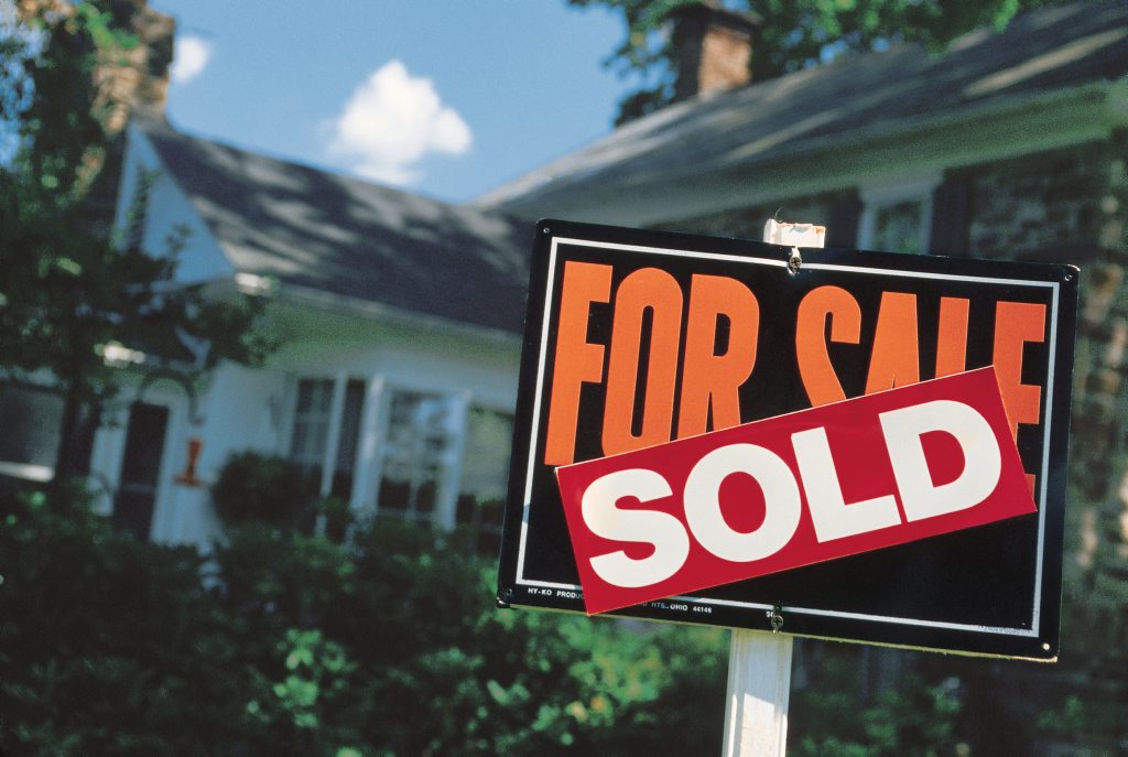Home with for sale - sold sign Home with for sale - sold sign