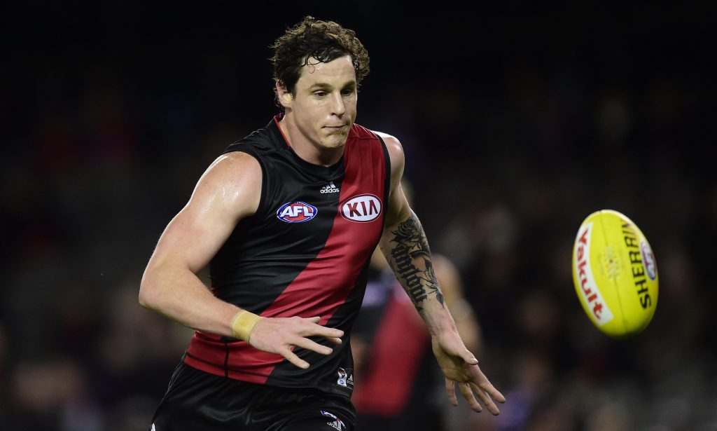 Essendon Bombers player Jake Carlisle chases the ball against the Western Bulldogs during round 18 of the AFL at Etihad Stadium in Melbourne, Sunday, Aug 2, 2015. (AAP Image/Julian Smith) NO ARCHIVING, EDITORIAL USE ONLY\ Essendon Bombers player Jake Carlisle chases the ball against the Western Bulldogs during round 18 of the AFL at Etihad Stadium in Melbourne, Sunday, Aug 2, 2015. (AAP Image/Julian Smith) NO ARCHIVING, EDITORIAL USE ONLY\