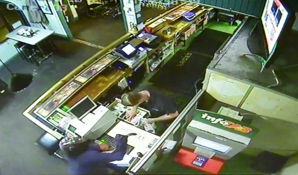 An armed robbery occurred at the Rising Sun Hotel in Rosewood on Sunday night. CCTV footage shows a man holding a curved knife as the bartender empties the cash register. Photo: Contributed An armed robbery occurred at the Rising Sun Hotel in Rosewood on Sunday night. CCTV footage shows a man holding a curved knife as the bartender empties the cash register. Photo: Contributed
