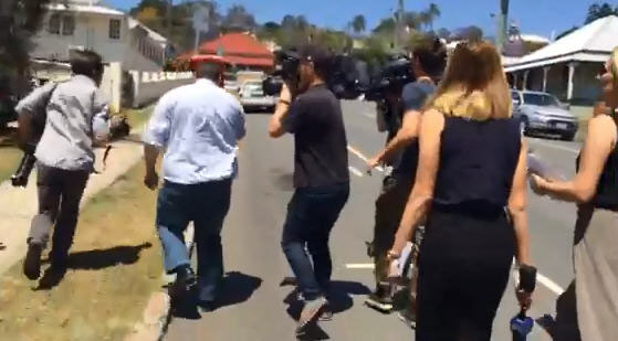A former Ipswich scout leader, who is facing 129 child exploitation offences, is pursued by a media scrum after being granted bail at Ipswich Magistrates Court. A former Ipswich scout leader, who is facing 129 child exploitation offences, is pursued by a media scrum after being granted bail at Ipswich Magistrates Court.