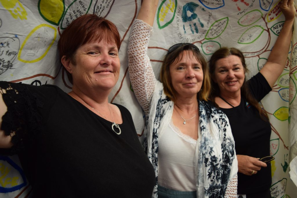 Phoenix House management committee member Trisha Mabley, director Helena Botros and BRC community division officer Bev Devlin holding the Reclaim the Night banner. Photo Ashley Clark / NewsMail Phoenix House management committee member Trisha Mabley, director Helena Botros and BRC community division officer Bev Devlin holding the Reclaim the Night banner. Photo Ashley Clark / NewsMail