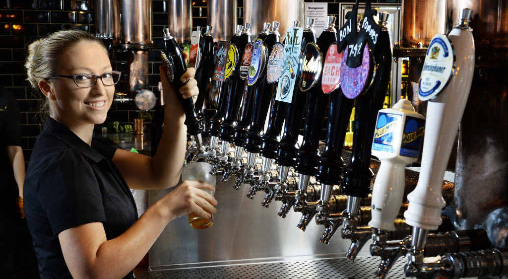 SPOILED FOR CHOICE: Bartender Megan Kent pours a drink from one of the 72 taps at the new Tap’d bar. SPOILED FOR CHOICE: Bartender Megan Kent pours a drink from one of the 72 taps at the new Tap’d bar.
